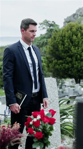 clip-4036691525-man-bible-priest-cemetery-funeral-service-flowers