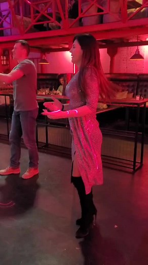 Glamorous Dance Performance in a Dimly Lit Bar