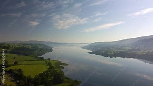 Aerial 4K Drone footage of Lake Bala, North Wales. Video moves across the wight of the lake showing the beautiful surroundings on a bright, sunny, summers day.