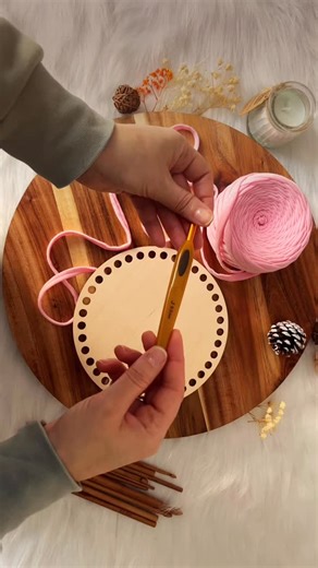T-shirt yarn baskets are taking over!💚 Save this video so you don’t forget to try it📌 Making baskets with wooden bases and chunky Rainbow T-shirt yarn is becoming super popular — and for good reason! They’re sturdy, stylish, and so satisfying to crochet🧶 In this video, I show how to cast on a 17 cm circular wooden base using 6 mm crochet hook and 7–9 mm thick Rainbow T-shirt yarn🧺 ✨UK crochet terms Instructions✨ 1. First round: work slip stitches into each hole of the base. 2. Second round: 