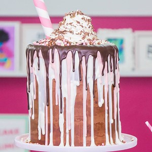 1M views · 1.1K shares | Mega sweet mega cakes  This GIANT Milkshake Mega Cake is quite the treat! It's made of marbled vanilla and chocolate cake stacked with Italian meringue and Swiss chocolate meringue buttercream and of course fresh strawberries and bananas. We topped it off with tri-chocolate drips, shavings, and crispy pearls 朗 | How To Cake It | Facebook