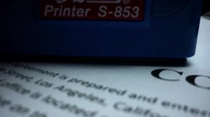 Rubber Stamp Making Seal on Contract, Red Stamp with Text Approved on Document