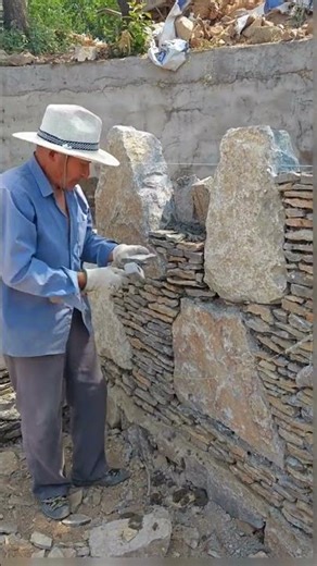 The process of building a wall with stones