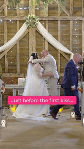 A funny moment just before the first kiss at a wedding ceremony.