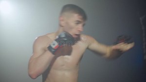 A Boxer Makes a Series of Punches on a Punching Bag Using His Arms and Legs Stock Footage - Video of opponent, black: 241524242