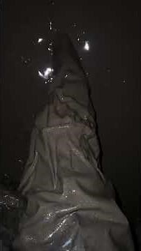 Stepping into deep mud in chest-high wader.