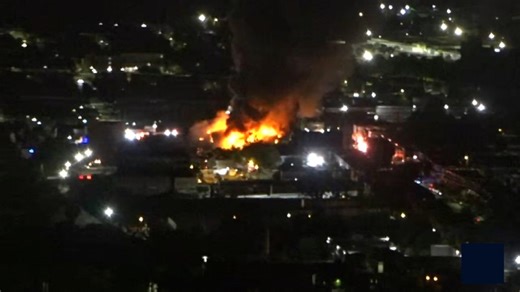 Massive fire burns at Baltimore mattress warehouse