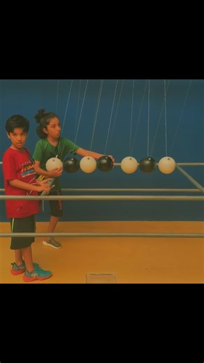 The game is a Newton’s Cradle (also called Newton’s Pendulum).