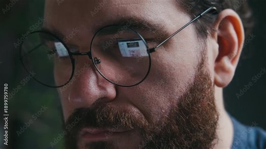 CloseUp Of White Man With Glasses, Intense LateNight Work Reflected In Lenses, Freelance Developer Reviewing Code, Quiet Home