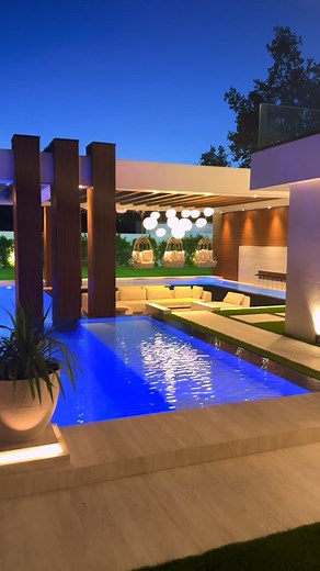 19K views · 11K reactions | Where architecture meets atmosphere. From the floating steps and zero-edge pool to the illuminated planters and cascading rain curtain, every element was designed to transform evening gatherings into an experience. A sunken seating area surrounded by water invites connection, while soft LED lighting sets the mood for effortless luxury. ✨ #LuxuryBackyardDesign #OutdoorEntertainmentSpace #ModernOutdoorLiving #ResortStyleDesign | Foxterra Design | Facebook