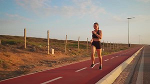 Woman Jogging on Running Track