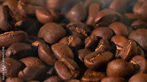 Super slow motion of flying coffee beans in speed ramping. Filmed on high speed cinema camera. morning coffee beans texture.