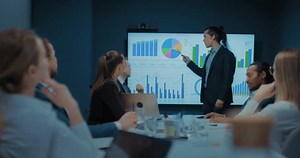 business expert speaking in front of investors in meeting room, speaker against chart, 4K, Prores