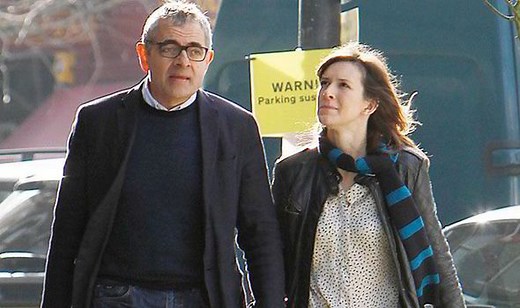 Rowan Atkinson, 60, holds hands with girlfriend Louise Ford, 32, ahead