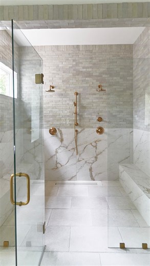 BuildTX Solutions on Instagram: "The perfect walk-in shower layout 👩🏻‍🎨 👇🏻 featuring double shower head + handheld for everyday comfort, a frameless glass enclosure that keeps the space visually clean, zellige and porcelain tiles adding texture and depth, a built-in bench designed for him & her, natural light pouring through the windows, and a layout that flows effortlessly and just makes sense. 🤍 Ready to optimize your primary bathroom? 👆🏻✨"