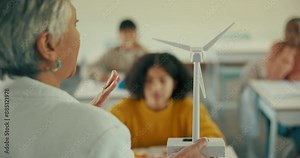 Teacher, classroom and lesson for clean energy or environment, eco friendly learning for planet. Professor, students and school with lecture for sustainable electricity, education with wind turbine Stock Video