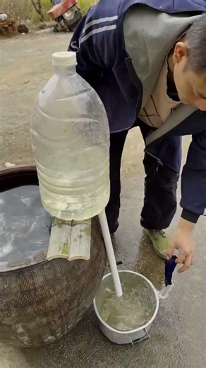 Testing the water pumping process with a homemade simple siphon device