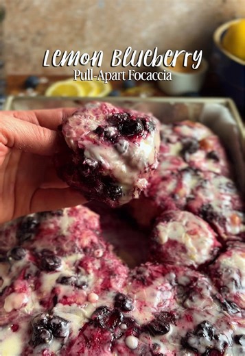 This must be what tasting the rainbow is like. Soft focaccia balls dipped in jammy blueberry compote, rolled in zesty lemon sugar, and finished with a sweet crackly lemon glaze. Spring is 21 days away and we are not waiting. Full recipe at: (screen shot and copy/paste into your browser) h3artofthehome.com/2026/02/26/lemon-blueberry-pull-apart-sourdough-focaccia #sourdough #sourdoughfocaccia #lemonblueberry #pullapartbread #springbaking