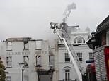Firefighters still tackling blaze at 'oldest hotel in England'