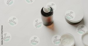 Animation of go green text and logos, over beauty cream jars and essential oil on white background