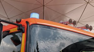 Flashing blue stroboscopic light on roof of emergency firefighters vehicle. Fire truck with flashing lights. Flasher fire engine. Vehicle lights siren