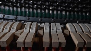 Inside the piano. Close-up view of hammers and strings inside the upright piano.