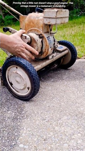 Firing up a vintage lawn mower.