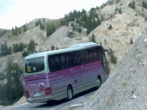 Alps, France - September 18 2013 : Purple Express Sundgoviens: Inside a Winding Mountain Road Journey - School Coach Bus Driving on Slope