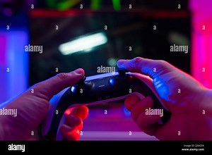 Modern gadgets for video games. Gamepad in the hand of a gamer. Isolated on a technological background. Video games, entertainment, recreation, new te Stock Photo - Alamy