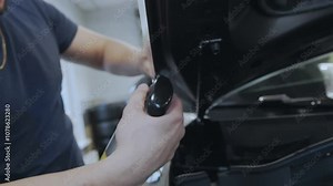 Car Service Worker Applying Protective Membrane to Car Hood. Protective Material against Corrosion and Stones. Car surface protection Stock Video