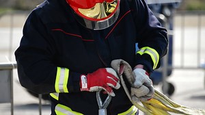 Firefighter working with ropes in rescue simulation of a traffic accident