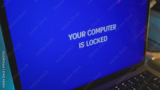 Extreme close up on computer screen message locked by hacker cybercrime attack. Laptop device is remotely accessed by spy or malware. Locking user out of computer with alarming alert message glitch