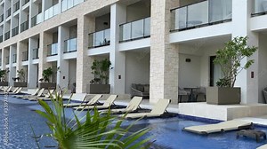 Infinity pool with deckchairs, luxury tropical holiday and vacation all-inclusive resort in Caribbean, modern swimming pool with loungers, zoom out movement