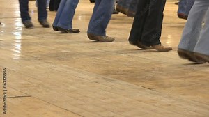 Cowboy dancing country line dance at a folk event, USA style. Legs stepping choreography American horse festival. Tradition jeans boots and flag Stock Video