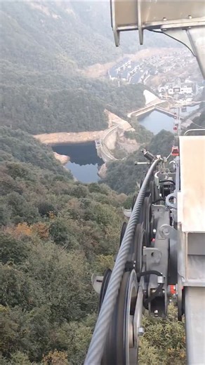 techy Universe | A high-altitude cable car system operating over a deep valley surrounded by dense forest and reservoirs below. In the foreground, you can... | Instagram