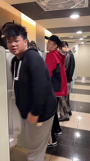 Young Men Hang Out in a Modern Public Restroom