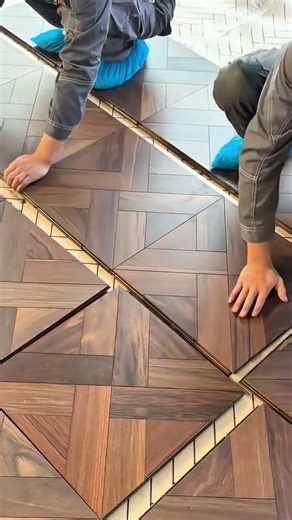 Installing wooden parquet flooring on the ground with precision and care