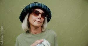 adult woman proudly and delightfully plays with a wad of money cash