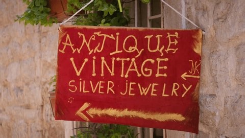 clip-3984341695-red-gold-hand-painted-sign-reading-antique-vintage