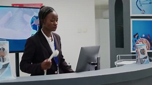 Young Receptionist Working Clinic Reception Counter Using Landline Phone Make
