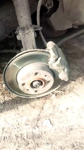 Close-Up Inspection of Car Brake Disc and Rotor