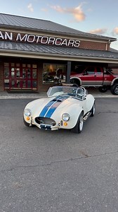 6.4K views · 977 reactions | CLASSIC‼️1965 @backdraft_racing Cobra  Wimbledon White with Gaurdsman Blue Stripes  Roush  Stack #JMCCobra #shelby #427 Full listing coming soon, call now to put your name on it! ☎️609-871-2700 JMCCobra.com | Jonathan Motorcars | Facebook