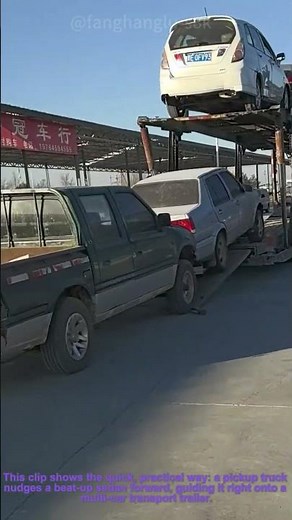 Junk Car Loaded onto Trailer: Pickup Pushes Wreck into Transport Rig