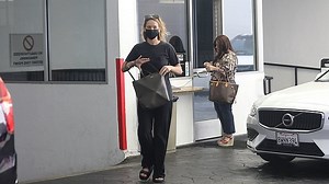 Jennifer Lawrence is a makeup-free beauty in a long black dress