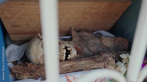 Corpse skull skeleton inside cemetery ossuary graveyard mayan traditional ethnic at Pomuch Campeche Mexico dia de los muertos day of the death