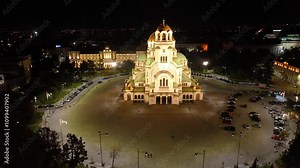 4K aerial night view of Bulgaria's capital Sofia. Iconic building. View of the Cathedral of St. Alexander Nevsky at nightfall, the largest church in the Balkans. Lateral movement. Streets and parks
