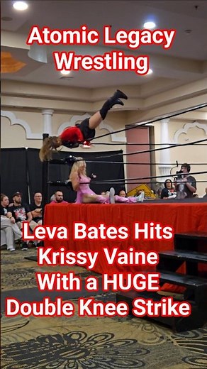 Leva Bates hits the returning Krissy Vaine with double knee strike in the corner at Atomic Wrestling