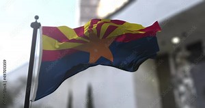Arizona state waving flag on blurry background, USA state news illustration. Blurry background