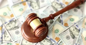 Judge gavel or auction on background of American money