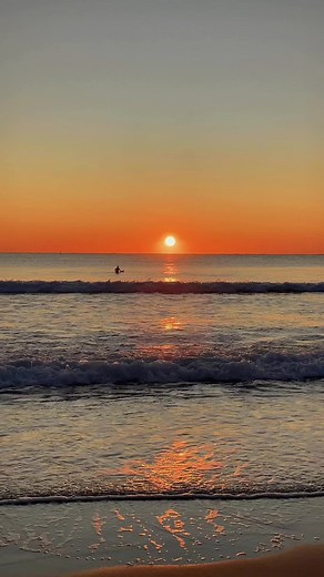 Sunset Surfers: Catching Waves in a Stunning Beach Scene